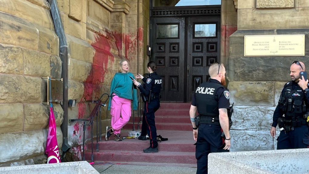 New Topless protester tosses paint, chains herself to PMO